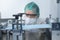 Close up of worker producing surgical mask in modern factory, Covid-19 protection and medical concept