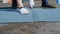 Close up of a worker s hands in gloves cutting a piece of roofing felt