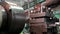 Close-up of worker setting up industrial steel machine. Stock footage. Hands of factory worker steel set up machine