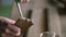 Close-up. a worker smears glue with a brush on a wood piece with a dovetail joint. handmade carpentry