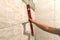 Close-up of worker tiler hand with lever installing on walls ceramic tiles. Tiles installation, tools and home improvement,
