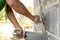 Close-up of workers using plaster trowel to plaster the walls for house construction.