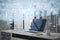 Close up of workplace with laptop and creative image of blurry cloud data icons on city background. Cloud computing, big data,