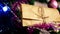 Close-up of a wrapped New Year`s gift wrapped in paper on a Christmas tree decorated with New Year`s decorations and garlands. A p