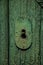 Close-up of wrought iron keyhole in an old wooden worn door