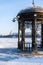 Close-up wrought pergola on waterfront of frozen city pond in center of Yekaterinburg in winter frosty day.