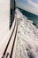 Close up of yacht mast and silver sail on blue sky background. Sailing boat part. Yachting, sailing, competitio