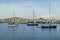 A close up of yachts moored in a sheltered bay with the backdrop of the shoreline of Arrecife, Lanzarote