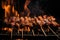 Close-up of yakitori skewers sizzling on a charcoal grill, with smoke rising and flames flickering in the background