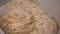 Close-up of yeast dough with raisins. Stock footage. Raw dough with sweet raisins ready for baking. Making sweet
