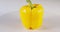 Close up a yellow bell pepper rotating on a white background