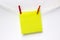 Close-Up Of yellow Blank Note Hanging Clothesline Against white Wall. Mock up