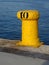 Close-up of a yellow bollard harbor