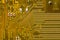 Close-up of a yellow circuit board. The reverse side of the motherboard of a personal computer. Background for