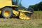 Close up of a yellow combine harvester