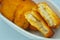 Close-up of yellow fried nuggets on a white background