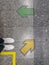 Close up Yellow and green arrow and white shoes on floor ground.