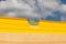 Close-up of a yellow hydro level with a green float against a blue sky on a summer day during the construction of a summer day