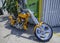 Close up of a yellow motorcycle chopper on a sidewalk