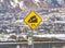 Close up of a yellow road grade sign with a truck on slope illustration