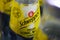 Close up of yellow Schweppes Indian tonic water bottle in container selective focus on center