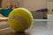 Close-up of a yellow tennis ball on the floor in the nursery