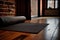 close-up of a yoga mat set up in the centre of an empty studio, with the studio\\\'s exposed brick walls (AIgen)