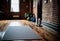 close-up of a yoga mat set up in the centre of an empty studio, with the studio\\\'s exposed brick walls (AIgen)