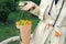 Close-up young adult fashion classy woman model hand holding authentic fresh orange spray roses flower bouquet wrapped