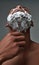 Close up of young african american man with foam applied on his face using steel razor for removing stubble from neck