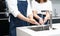 Close up of young Asian couple washing his hands in the modern kitchen sink before and after cooking. Hygiene Concept. Protection