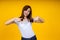 Close up of young Asian woman isolated on yellow background showing thumps up