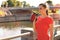 Close up of a young attractive tired sportswoman outdoors, drinking water from a bottle