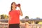 Close up of a young attractive tired sportswoman outdoors, drinking water from a bottle