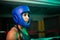Close-up of young boxer girl in protective helmet
