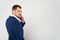 Close up of young business man in suit speaks on cell phone on white background