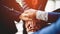 Close-up of young business people shaking hands. Demonstrates excellent work. laying hands to encourage work Unity and