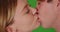 Close up of young Caucasian couple kissing on green screen