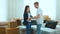 Close up of young Caucasian husband and wife dancing in room in new apartment on moving day. Joyful married couple dance