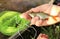 Close-up of a young caucasian male`s hand holding a caught fish and placing it in a live fish basket