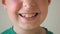 Close up of young child mouth smiling and laughing indoor. Portrait of handsome boy with glad expression on face. Happy