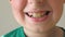 Close up of young child mouth smiling and laughing indoor. Portrait of handsome boy with glad expression on face. Happy
