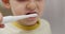 Close-up of a young child using an electric toothbrush, focusing on oral hygiene