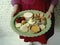 A close up of a young childs plate filled with only a few items of food.. AI generation