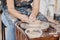 Close-up of young creative craftswoman skilled in pottery creating new item