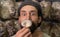 Close-up of Young cute farmer man sniffing a mushroom