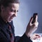 Close up of young desperate and angry woman screaming and talking on telephone