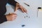 Close-up of a young, enterprising architect at work at his desk in his office. Drawing a new product on white paper. The artist`s