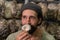 Close-up of Young farmer man sniffing a mushroom