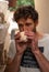 Close-up of Young farmer man sniffing a mushroom